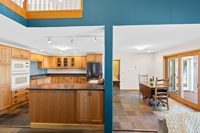 kitchen with white appliances, sink, and tasteful backsplash