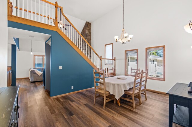 dining area featuring high vaulted ceiling, an inviting chandelier, and dark hardwood / wood-style flooring