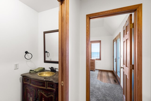 hall featuring hardwood / wood-style floors and sink