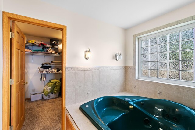 bathroom with a relaxing tiled tub