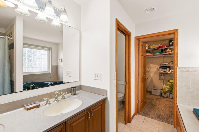 bathroom with vanity, toilet, and tile patterned floors