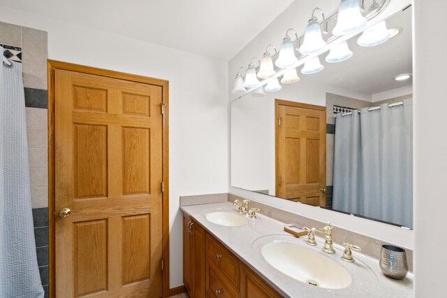 bathroom with walk in shower and vanity