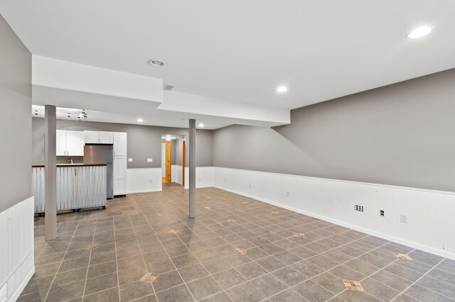 basement with stainless steel refrigerator