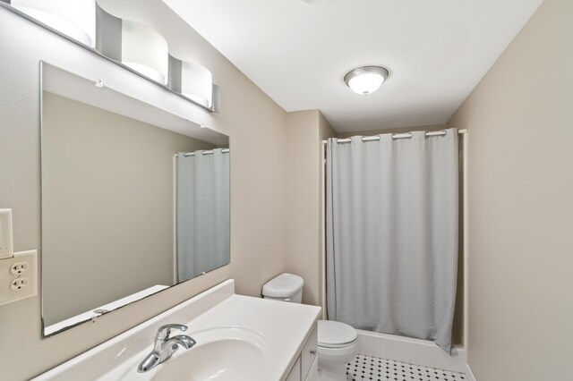 bathroom featuring vanity, tile patterned floors, toilet, and curtained shower