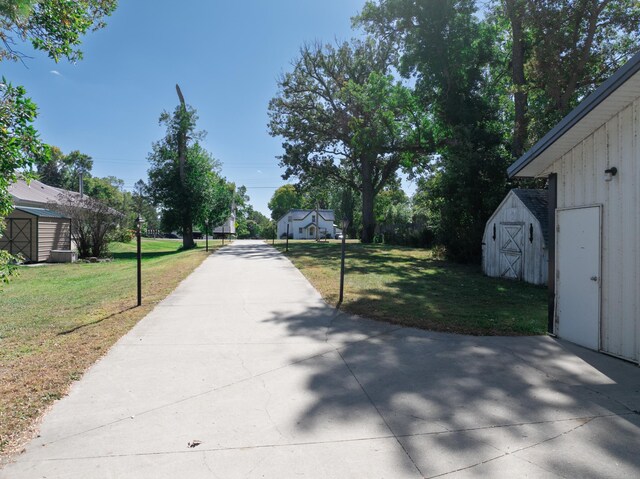 exterior space with a lawn and a storage unit