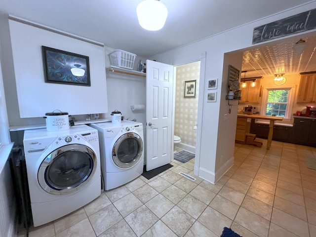 laundry area featuring light tile patterned flooring and washer and dryer