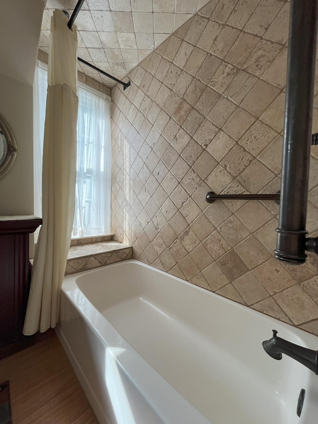 bathroom with shower / bath combination with curtain and hardwood / wood-style floors