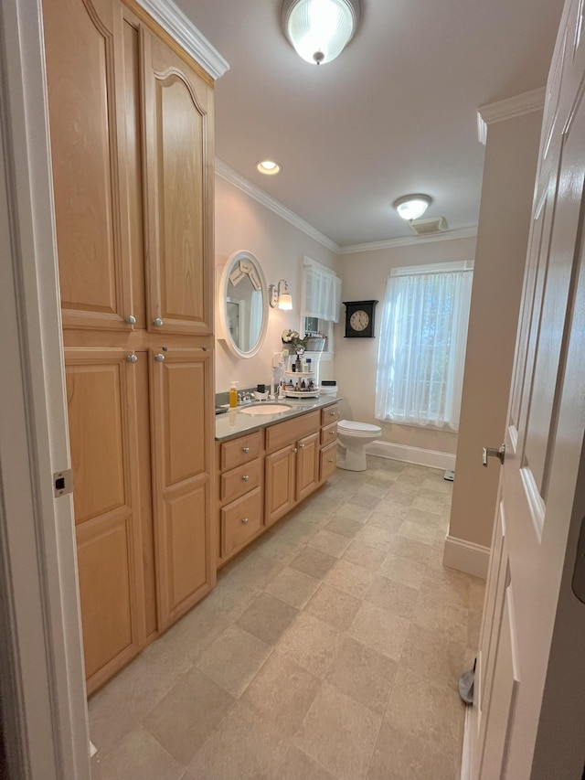 bathroom featuring crown molding, vanity, and toilet