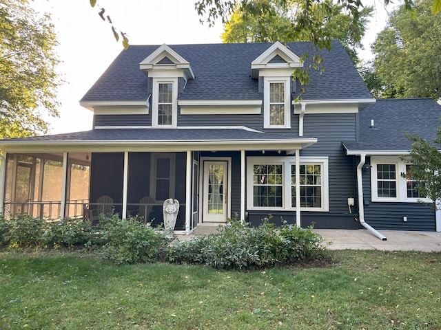 rear view of house with a yard and a patio area