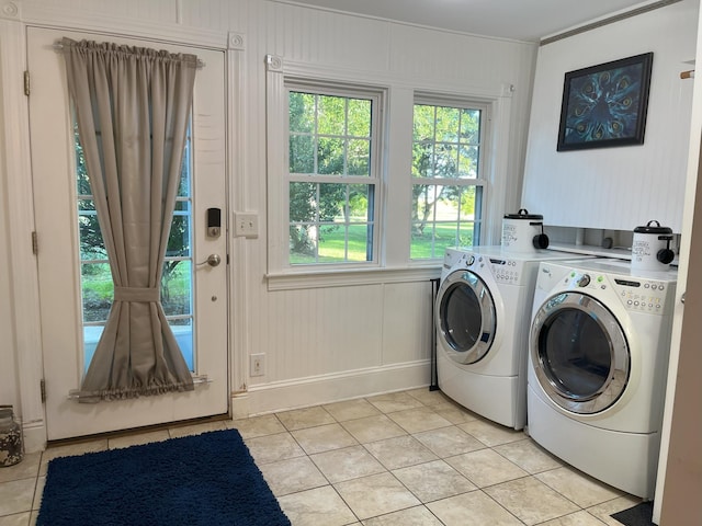 washroom with separate washer and dryer and light tile patterned floors