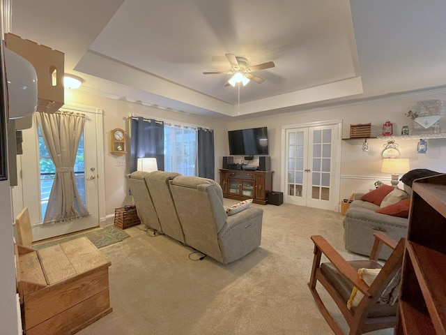 living room featuring french doors, carpet, and a tray ceiling