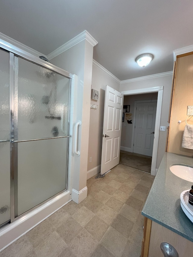 bathroom with crown molding, vanity, and an enclosed shower