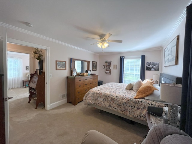 bedroom featuring crown molding, light colored carpet, and ceiling fan