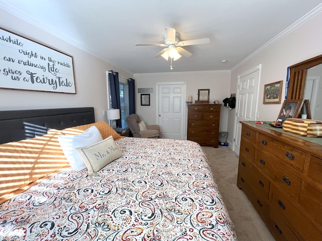 carpeted bedroom featuring ornamental molding and ceiling fan