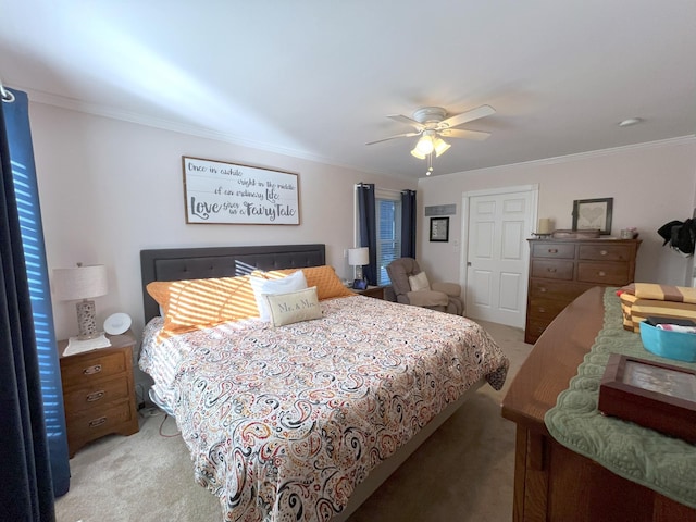 carpeted bedroom with crown molding and ceiling fan