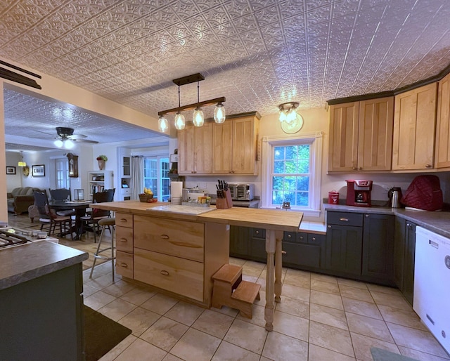 kitchen featuring ceiling fan, white dishwasher, light tile patterned flooring, wood counters, and decorative light fixtures