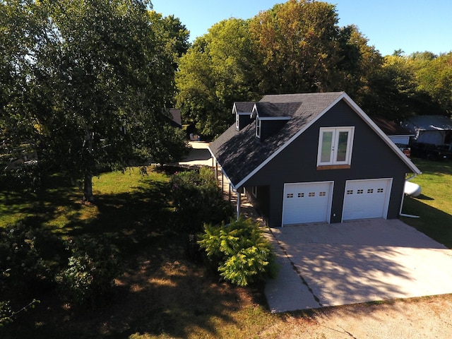 view of home's exterior featuring a garage and a yard