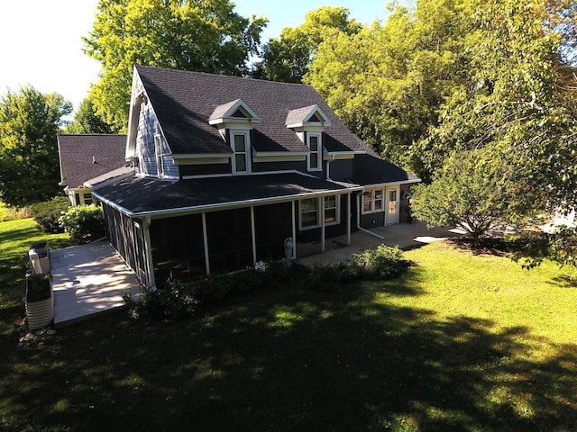 back of house featuring a sunroom, a yard, and a patio area