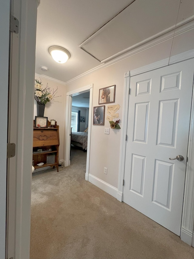 hall featuring light carpet and crown molding