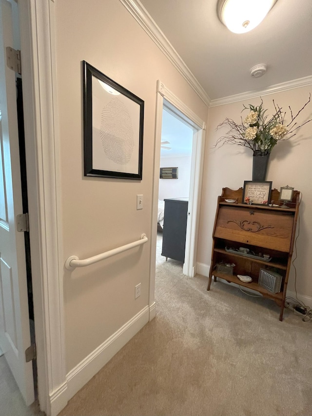 corridor featuring crown molding and light colored carpet