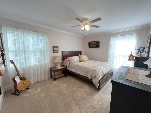 carpeted bedroom with multiple windows, ornamental molding, and ceiling fan