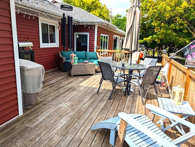 deck with area for grilling and outdoor lounge area