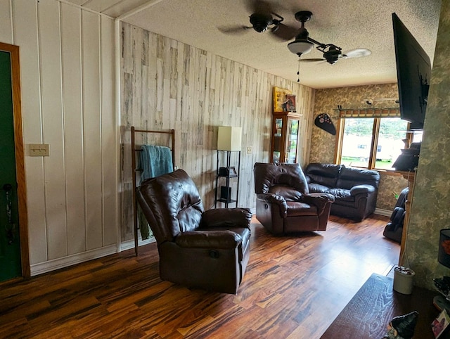 506 Ash Ave N, New Richland, MN 56072 - living room with wooden walls, a ceiling fan, wood finished floors, and a textured ceiling