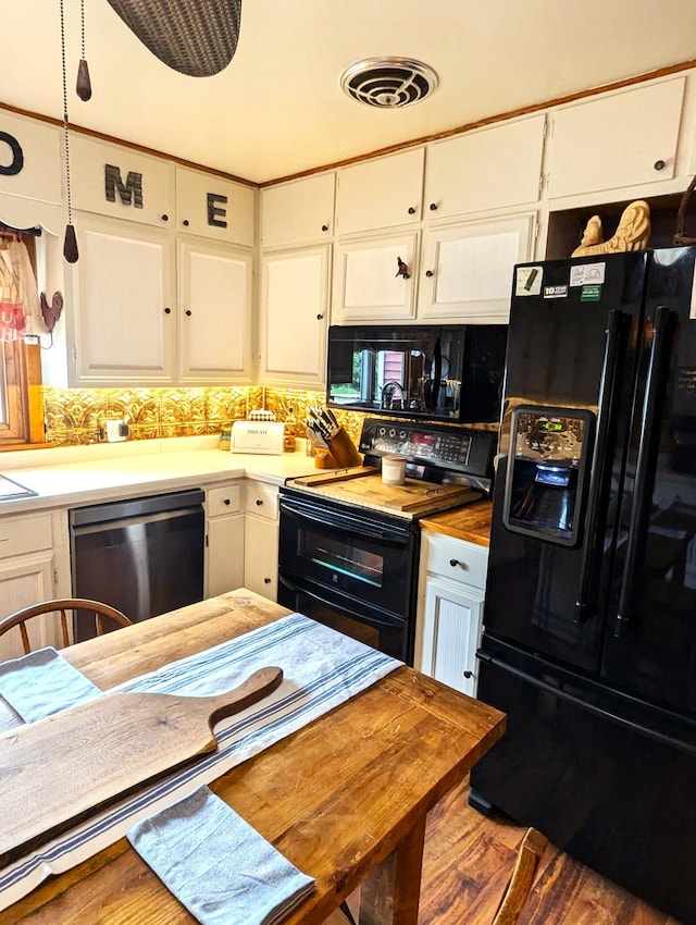 506 Ash Ave N, New Richland, MN 56072 - kitchen with wood finished floors, butcher block countertops, black appliances, white cabinetry, and visible vents