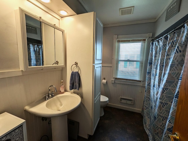 506 Ash Ave N, New Richland, MN 56072 - full bathroom with wood walls, a wainscoted wall, toilet, ornamental molding, and visible vents