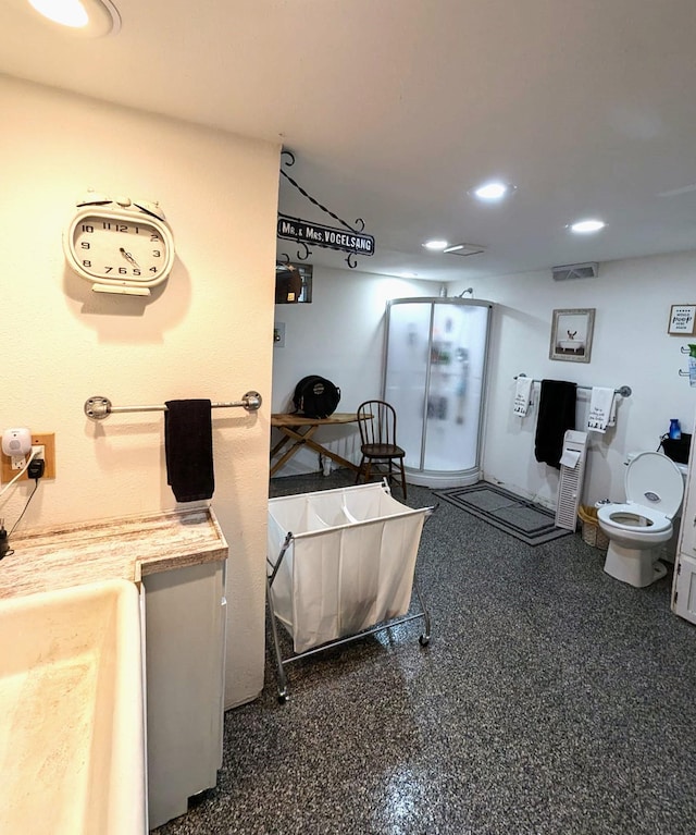 506 Ash Ave N, New Richland, MN 56072 - miscellaneous room with recessed lighting, visible vents, and speckled floor