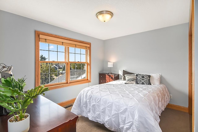 bedroom with visible vents, baseboards, and carpet