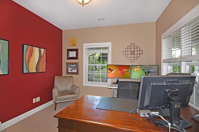 carpeted home office featuring baseboards