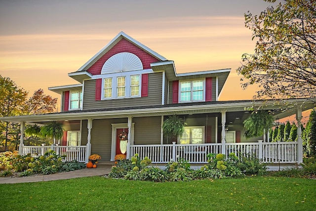 view of front of home featuring a lawn and covered porch