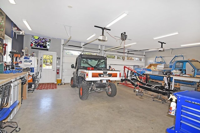 garage with a workshop area and a garage door opener