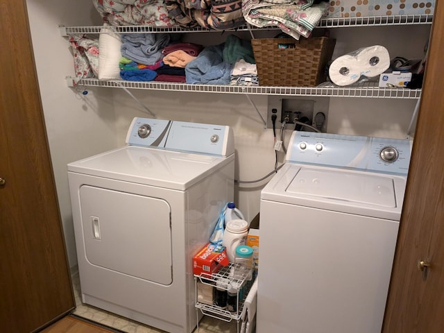 laundry room featuring light wood-type flooring and washing machine and dryer