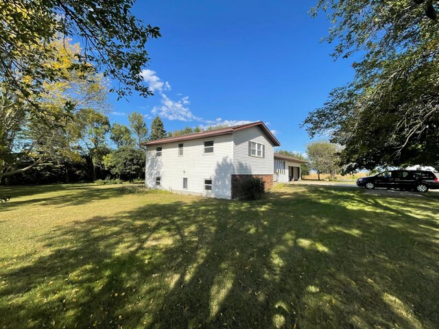 rear view of property with a lawn