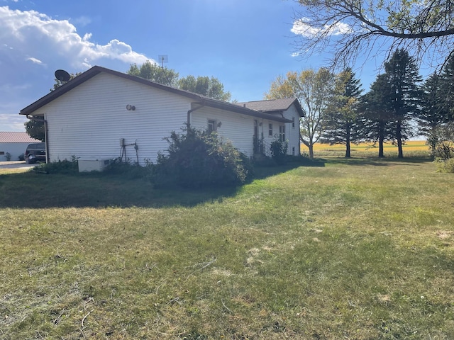 view of side of home featuring a yard