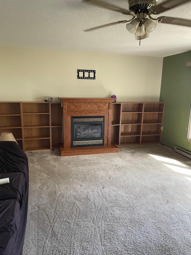 unfurnished living room with carpet, ceiling fan, and a textured ceiling