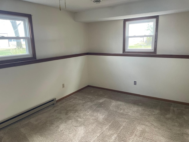 carpeted spare room with baseboard heating