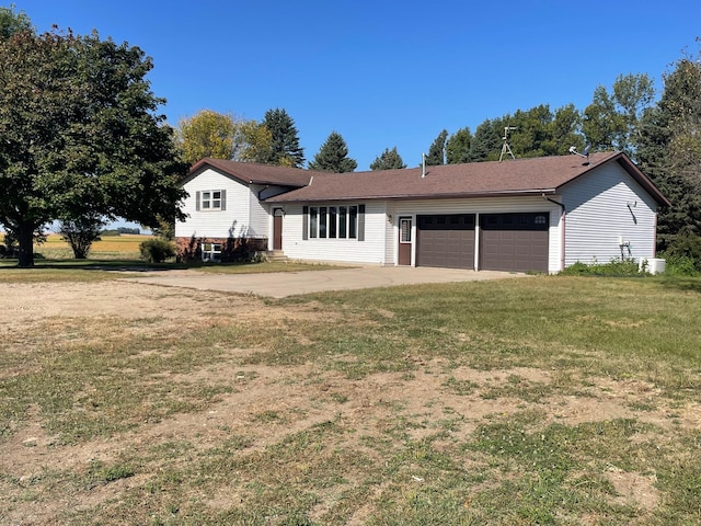 ranch-style home featuring a garage and a front lawn