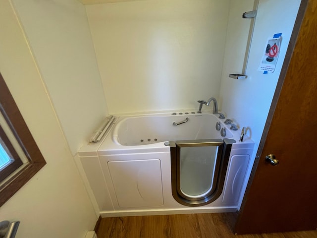 bathroom featuring hardwood / wood-style flooring and a bathtub