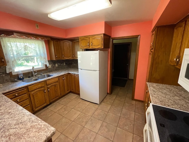 kitchen with light tile patterned floors, sink, white appliances, and decorative backsplash