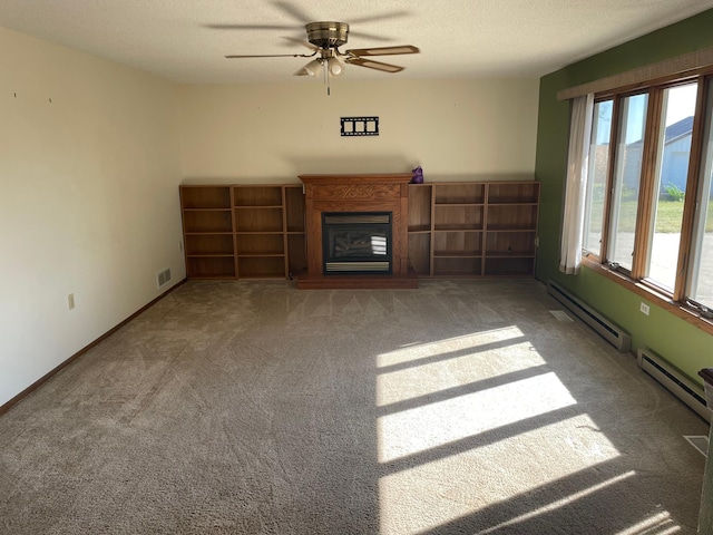 unfurnished living room with carpet floors, a textured ceiling, ceiling fan, and a baseboard radiator