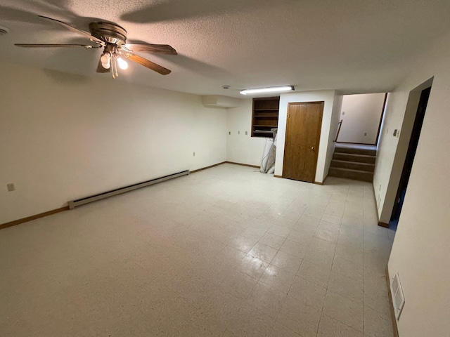 unfurnished bedroom featuring a textured ceiling, ceiling fan, and a baseboard heating unit