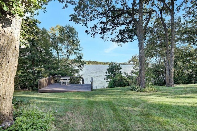 view of yard with a deck with water view