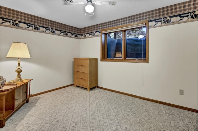 interior space with ceiling fan and light colored carpet