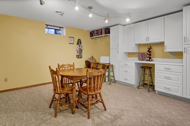 dining room with light carpet