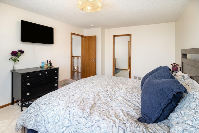 carpeted bedroom with a textured ceiling