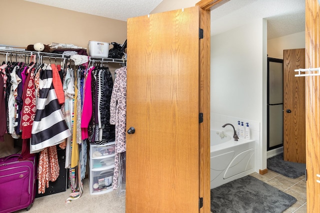 walk in closet with tile patterned floors