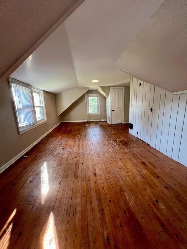 bonus room featuring hardwood / wood-style flooring, lofted ceiling, and a wealth of natural light